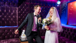 Bride and groom singing karaoke