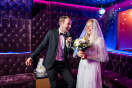Bride and groom singing karaoke