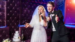 Bride and groom singing karaoke