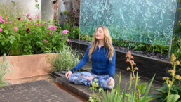 Woman meditating in a garden